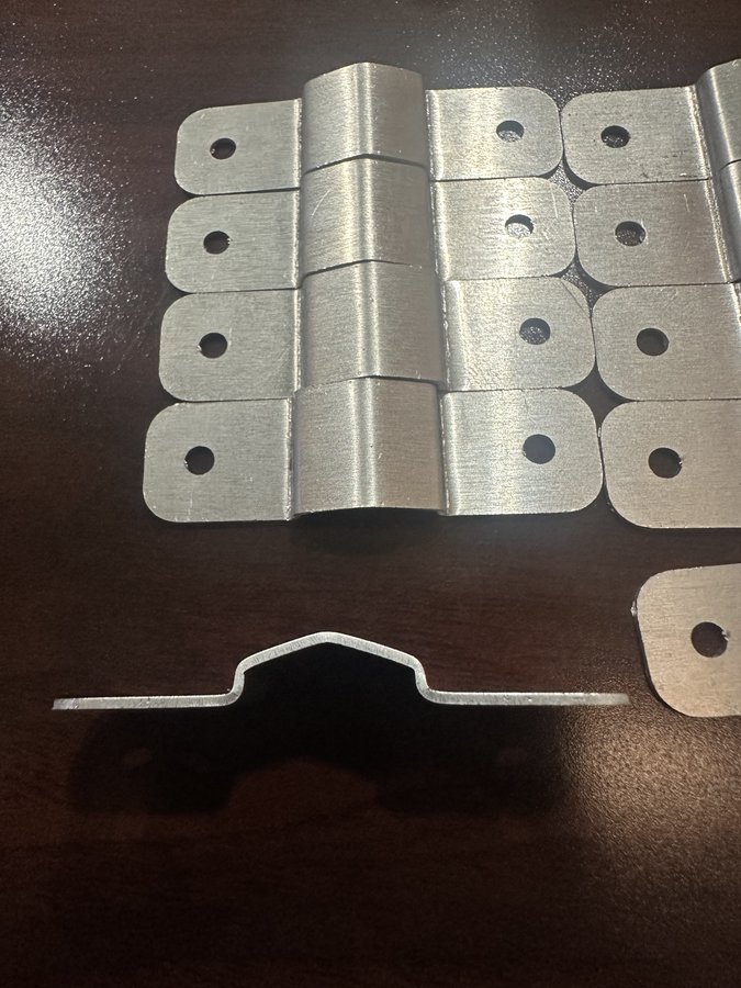 Formed sheet metal channel brackets with punched mounting slots